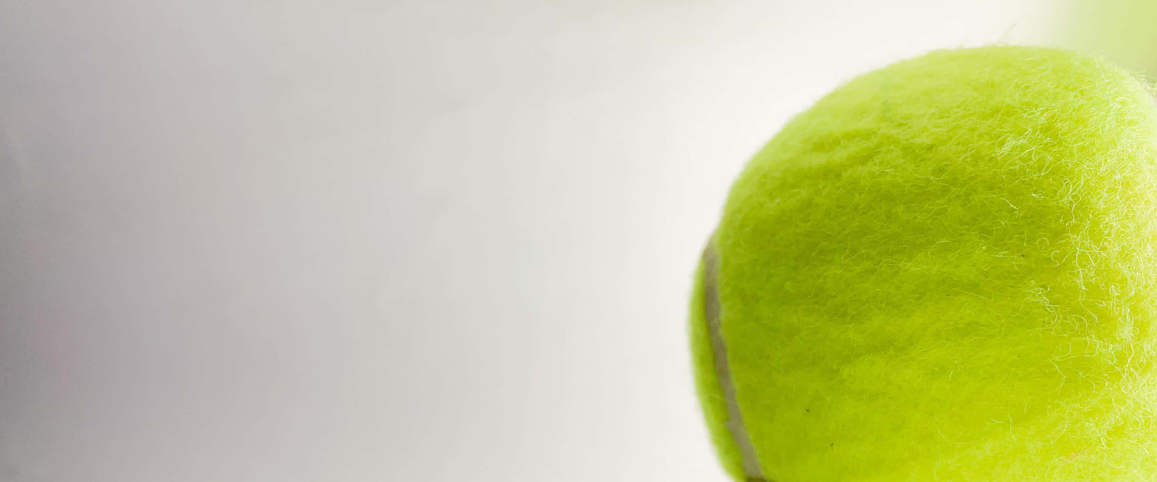 A tennis ball bleeding off the ride side of the header image.