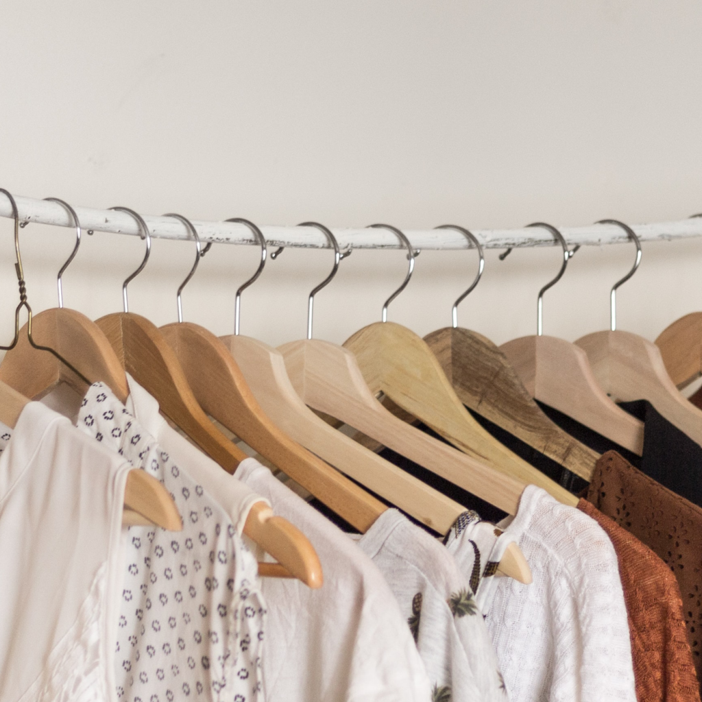 Clothes hanging on wooden hangers.
