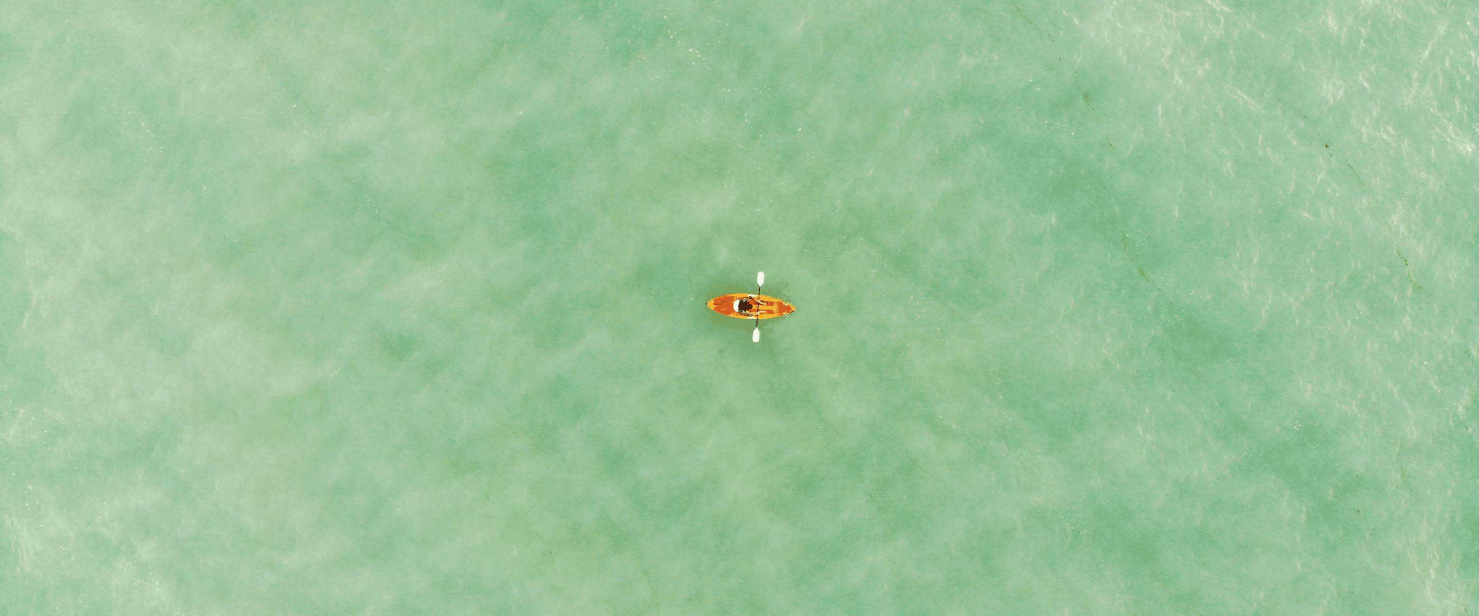 An aerial view of a kayak in water.