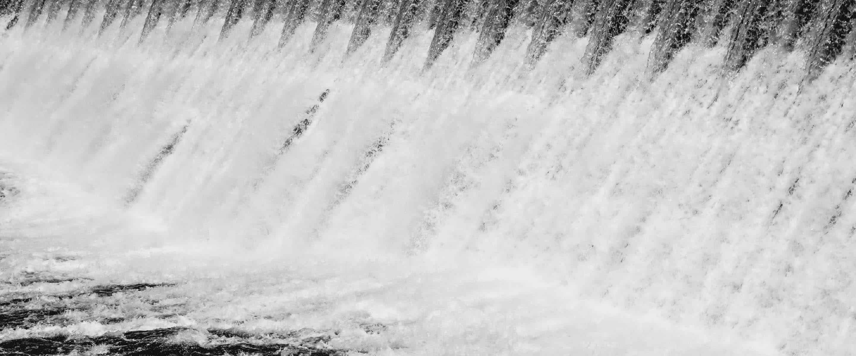 An image of water rushing through a dam.