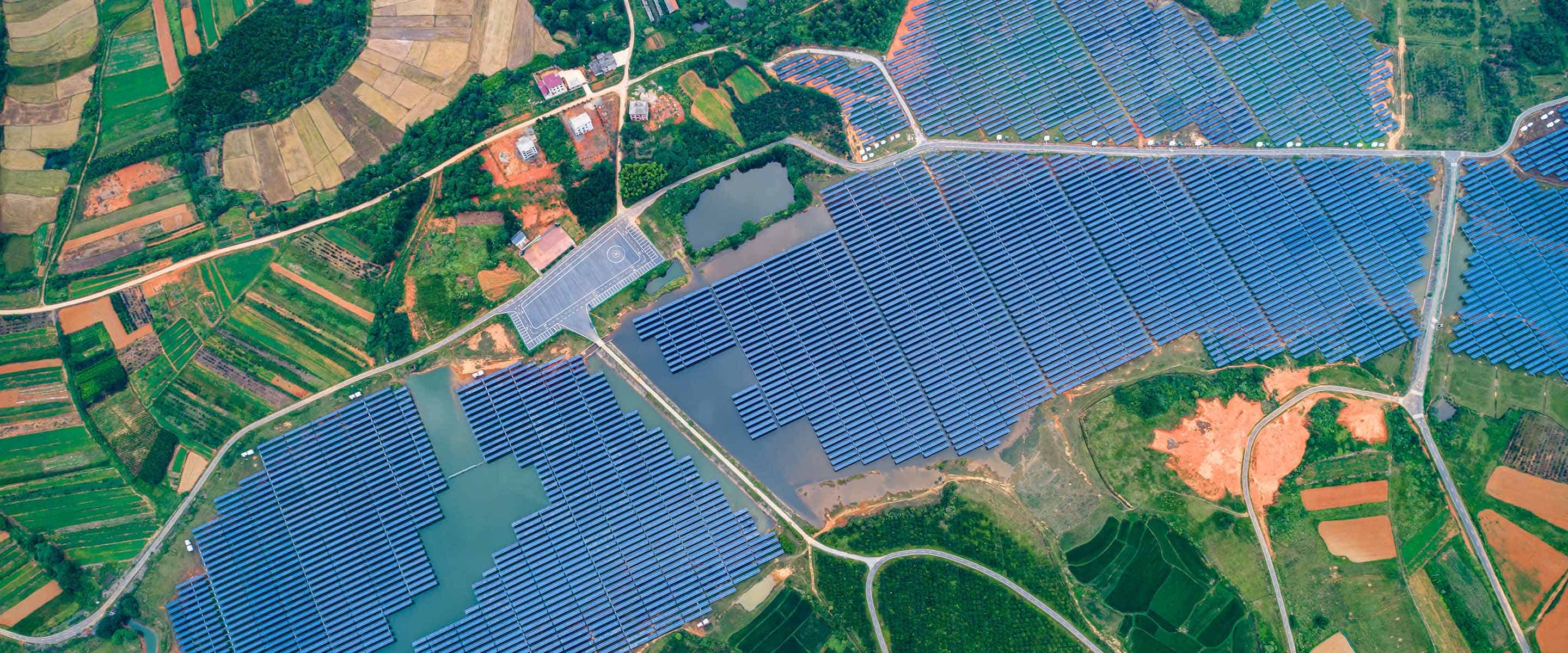 Overhead image of a field with solar panels.