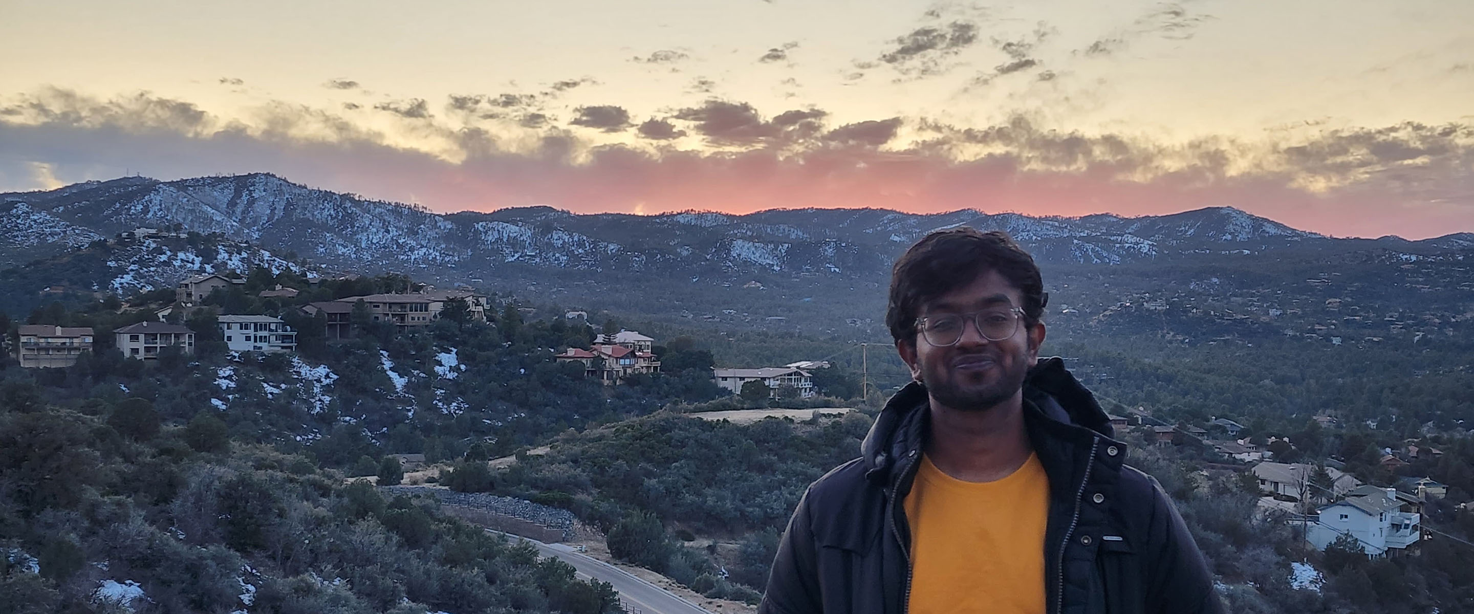 SAthya with mountains in the background.